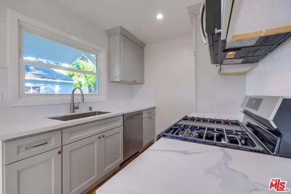 a kitchen with sink a window and appliances