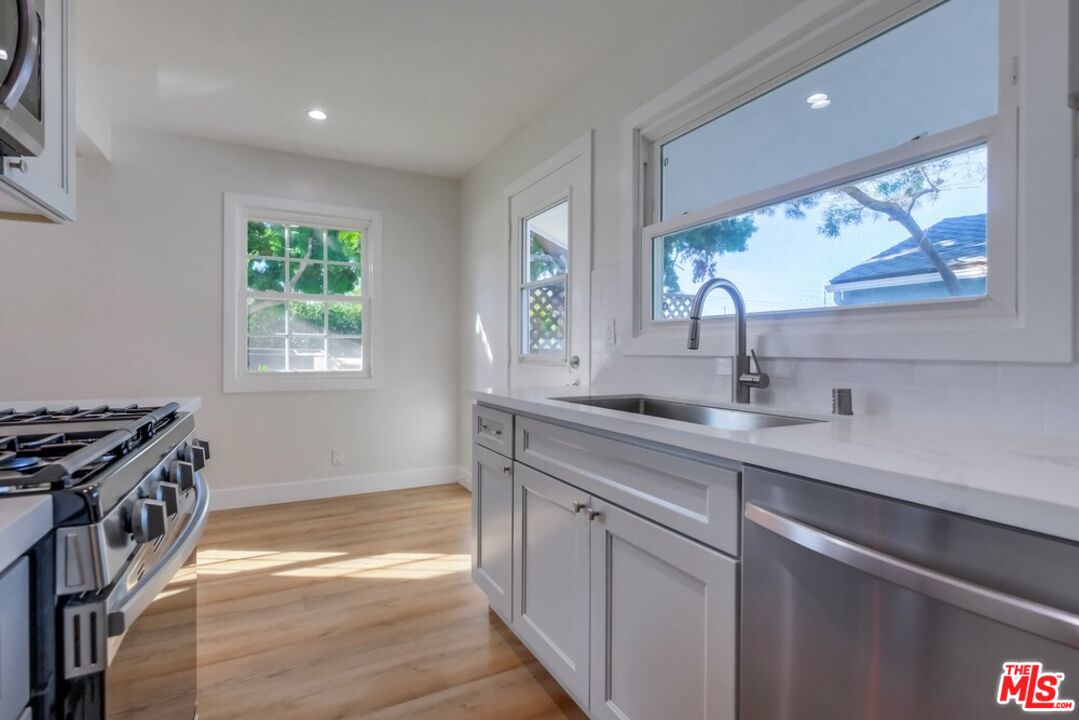 8356 Kittyhawk Avenue Los Angeles, CA 90045 - Photo 13 of 24 a kitchen with a sink and a stove