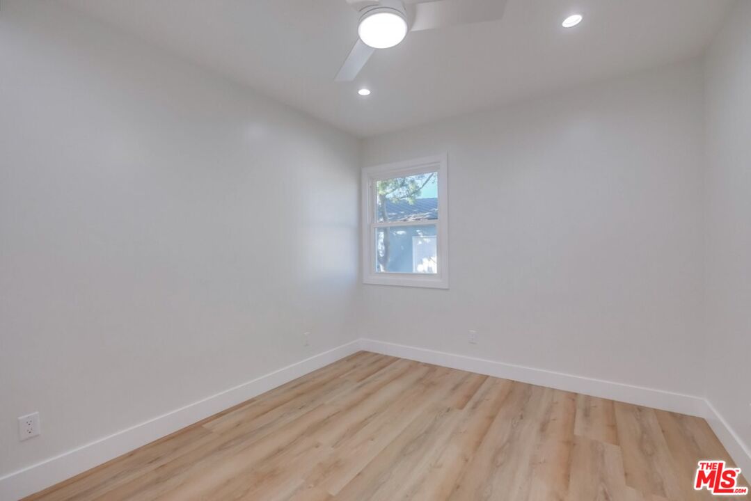 8356 Kittyhawk Avenue Los Angeles, CA 90045 - Photo 14 of 24 a view of an empty room with wooden floor and a window