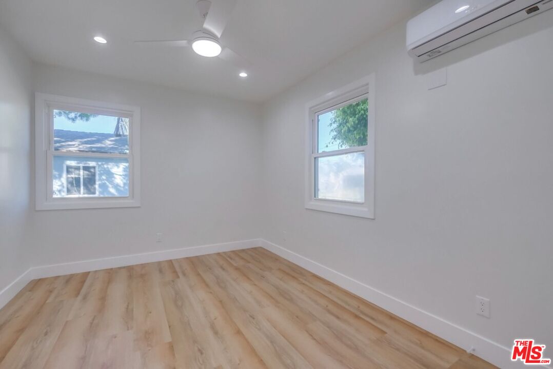 8356 Kittyhawk Avenue Los Angeles, CA 90045 - Photo 15 of 24 wooden floor in an empty room with a window