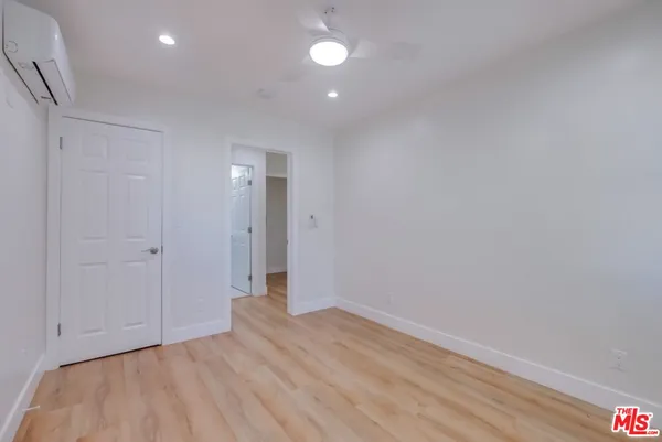 a view of empty room with wooden floor