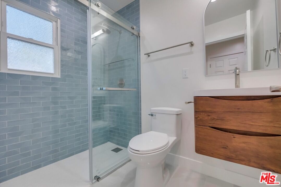 8356 Kittyhawk Avenue Los Angeles, CA 90045 - Photo 17 of 24 a bathroom with a toilet a sink and shower