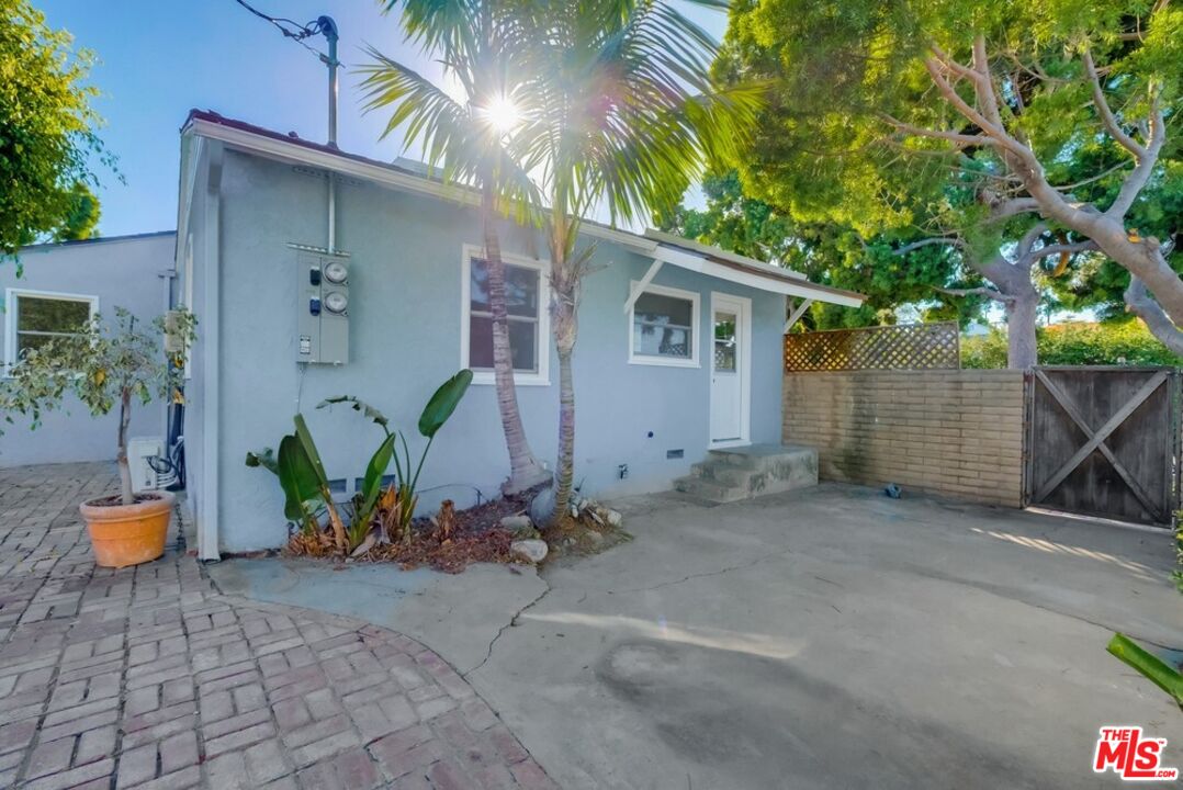 8356 Kittyhawk Avenue Los Angeles, CA 90045 - Photo 22 of 24 a backyard of a house with potted plants and a tree