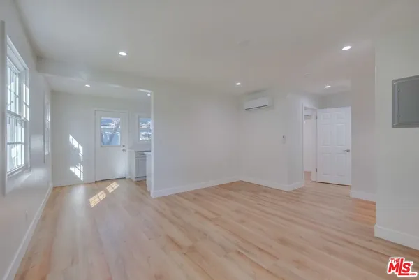 a view of empty room with wooden floor