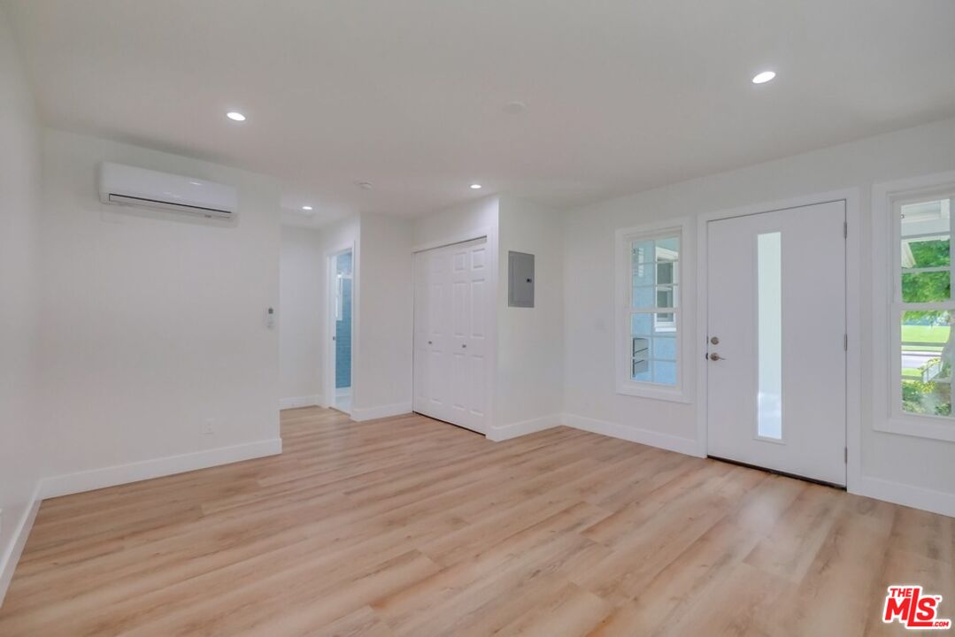 8356 Kittyhawk Avenue Los Angeles, CA 90045 - Photo 4 of 24 a view of an empty room with wooden floor and a window