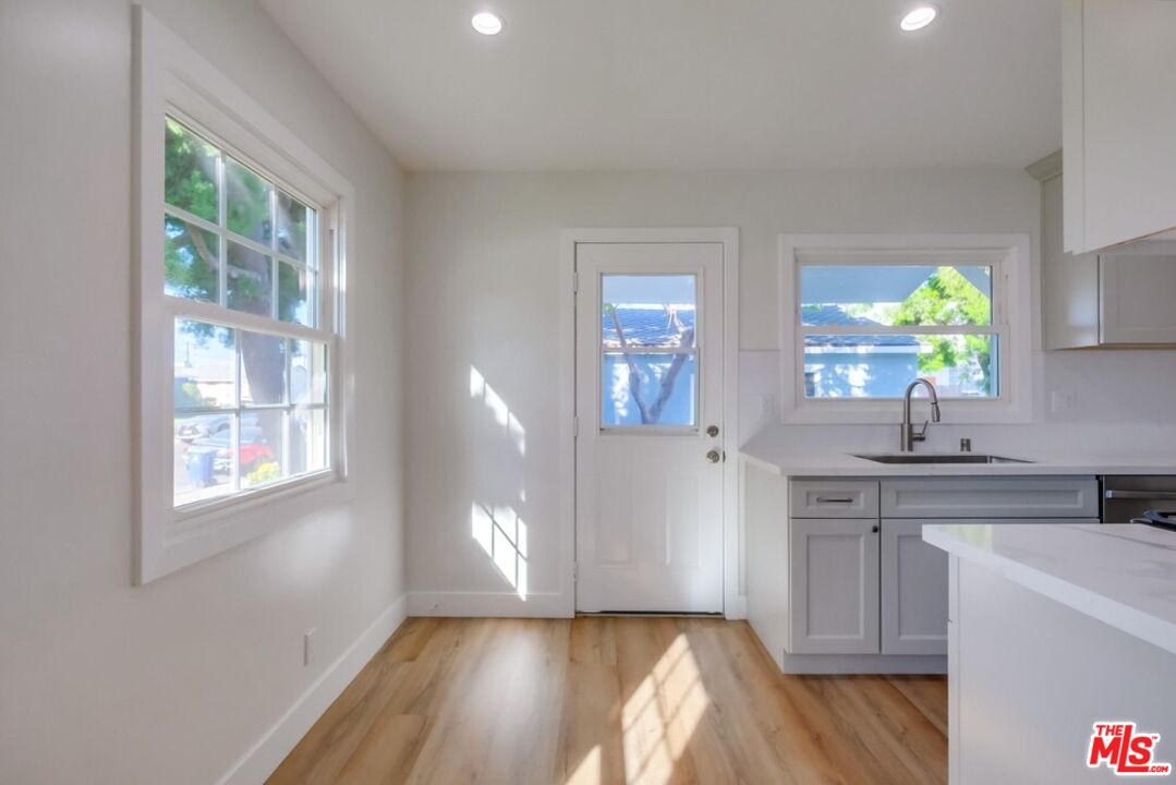 8356 Kittyhawk Avenue Los Angeles, CA 90045 - Photo 6 of 24 a kitchen with a sink a window and cabinets