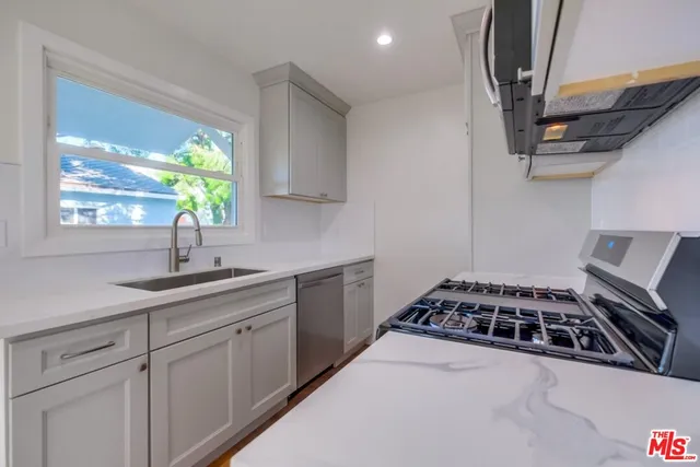a kitchen with sink a window and appliances