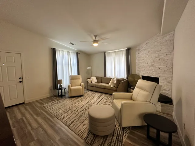 a living room with furniture and a fireplace