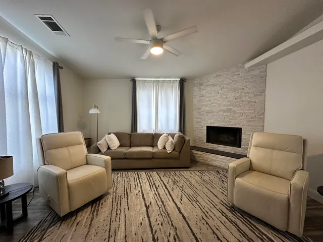 a living room with furniture and a fireplace