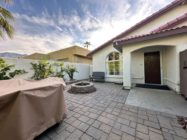 a view of house with backyard and seating space