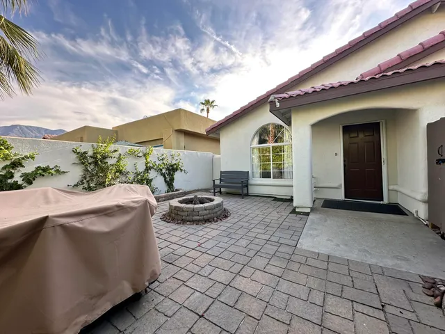 a view of house with backyard and seating space