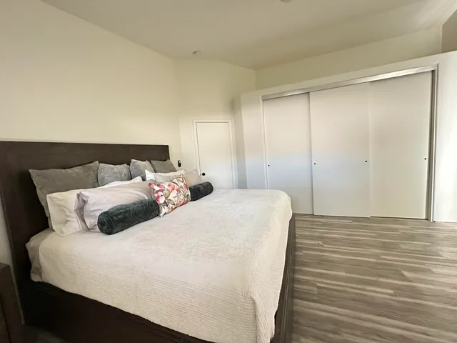 a bedroom with a bed and a night stand