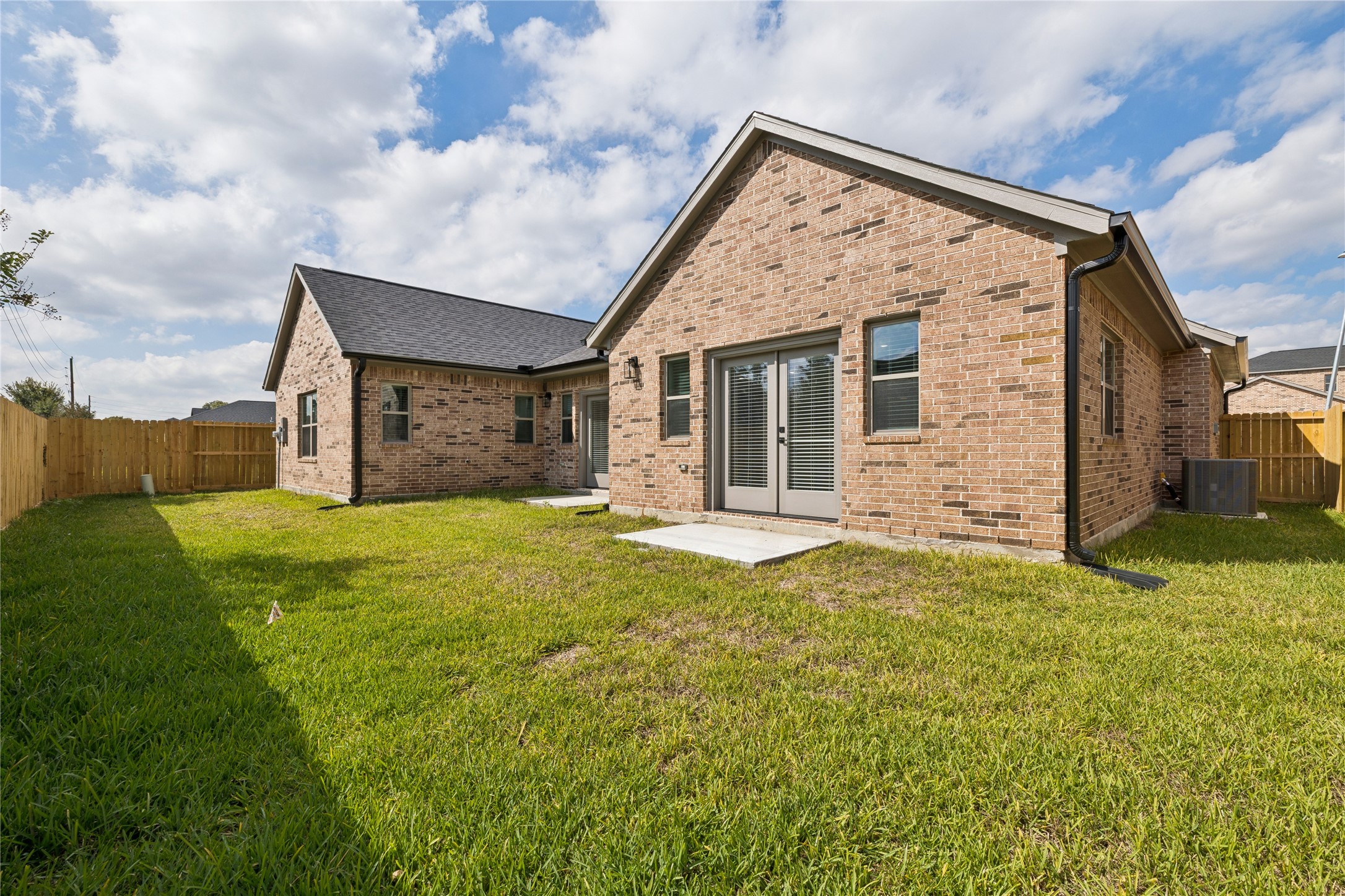 2618 Martinas Ct Spring Spring, TX 77388 - Photo 23 of 33 Charming brick home with a spacious fenced backyard. Features a patio area with French doors, perfect for outdoor entertaining.
