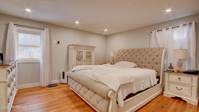 a spacious bedroom with a bed and a window