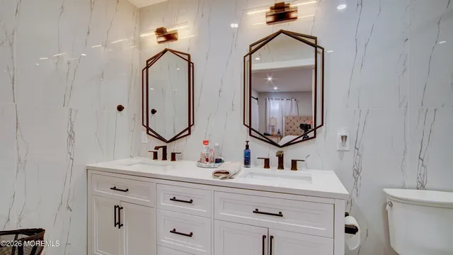 a bathroom with a sink double vanity and a mirror