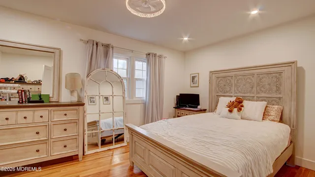 a bedroom with a large bed and a dresser