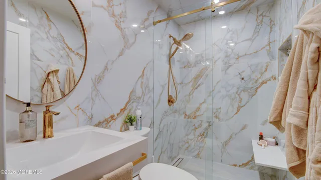 a bathroom with a sink a toilet and a mirror