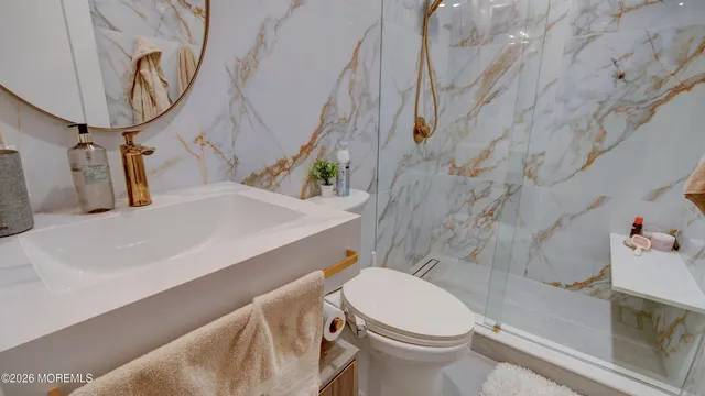 a bathroom with a sink a toilet and a mirror