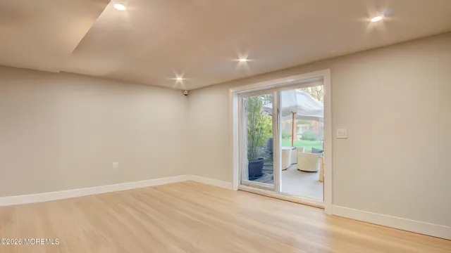 a kitchen with stainless steel appliances kitchen island granite countertop a dining table chairs refrigerator and a sink