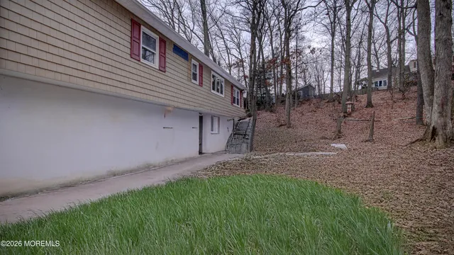 a white house with a small yard and a fountain