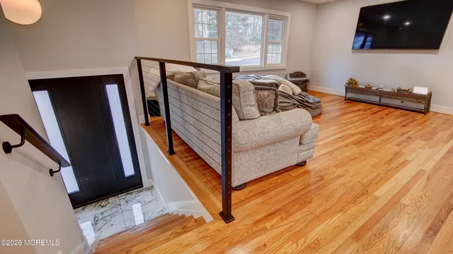 a view of a livingroom with furniture and stairs