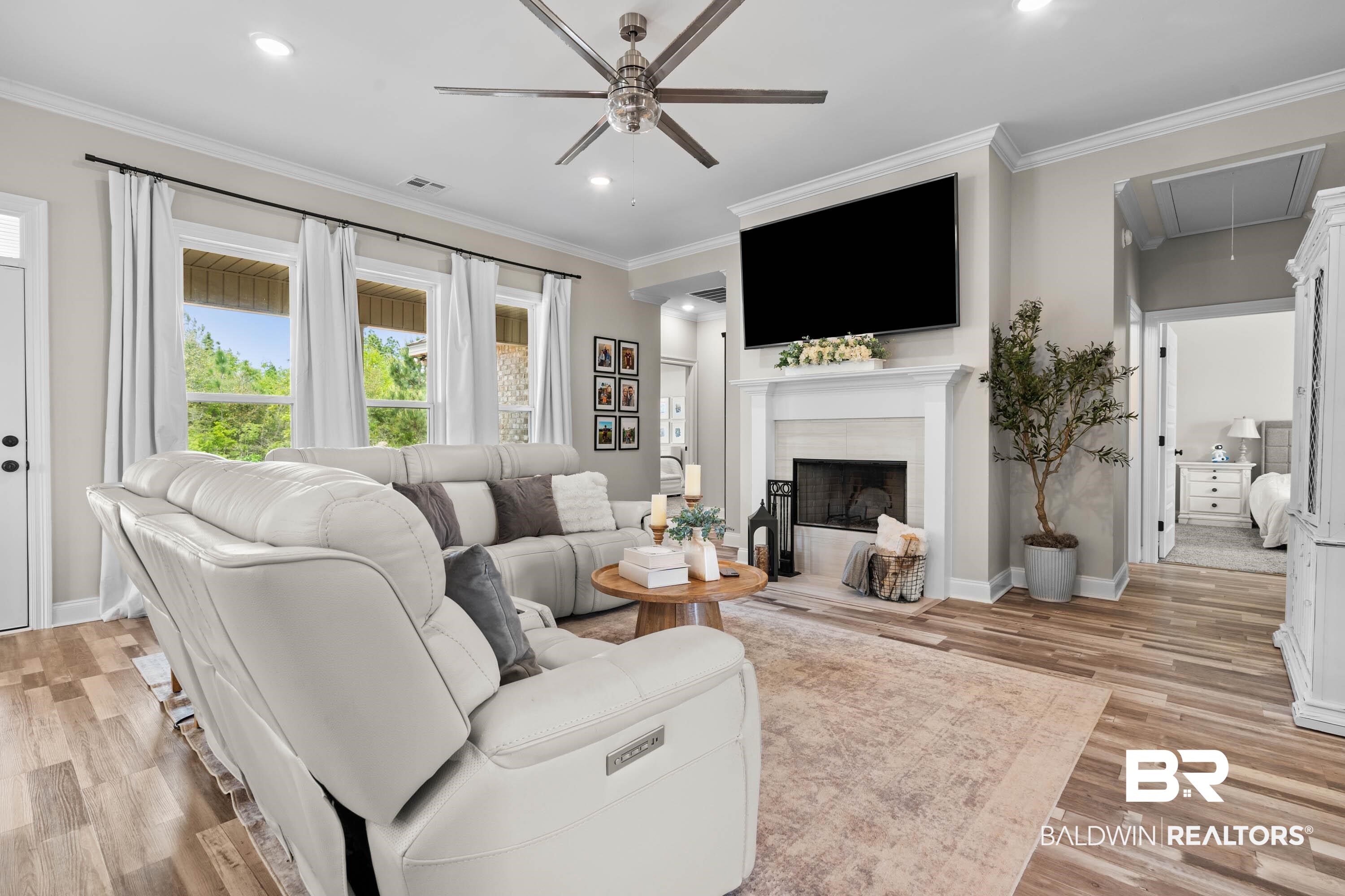 7150 Powell Road, Unit LOT 6A Eight Mile, AL 36613 - Photo 4 of 35 Living area featuring a ceiling fan, light wood-style floors, crown molding, a tile fireplace, and recessed lighting