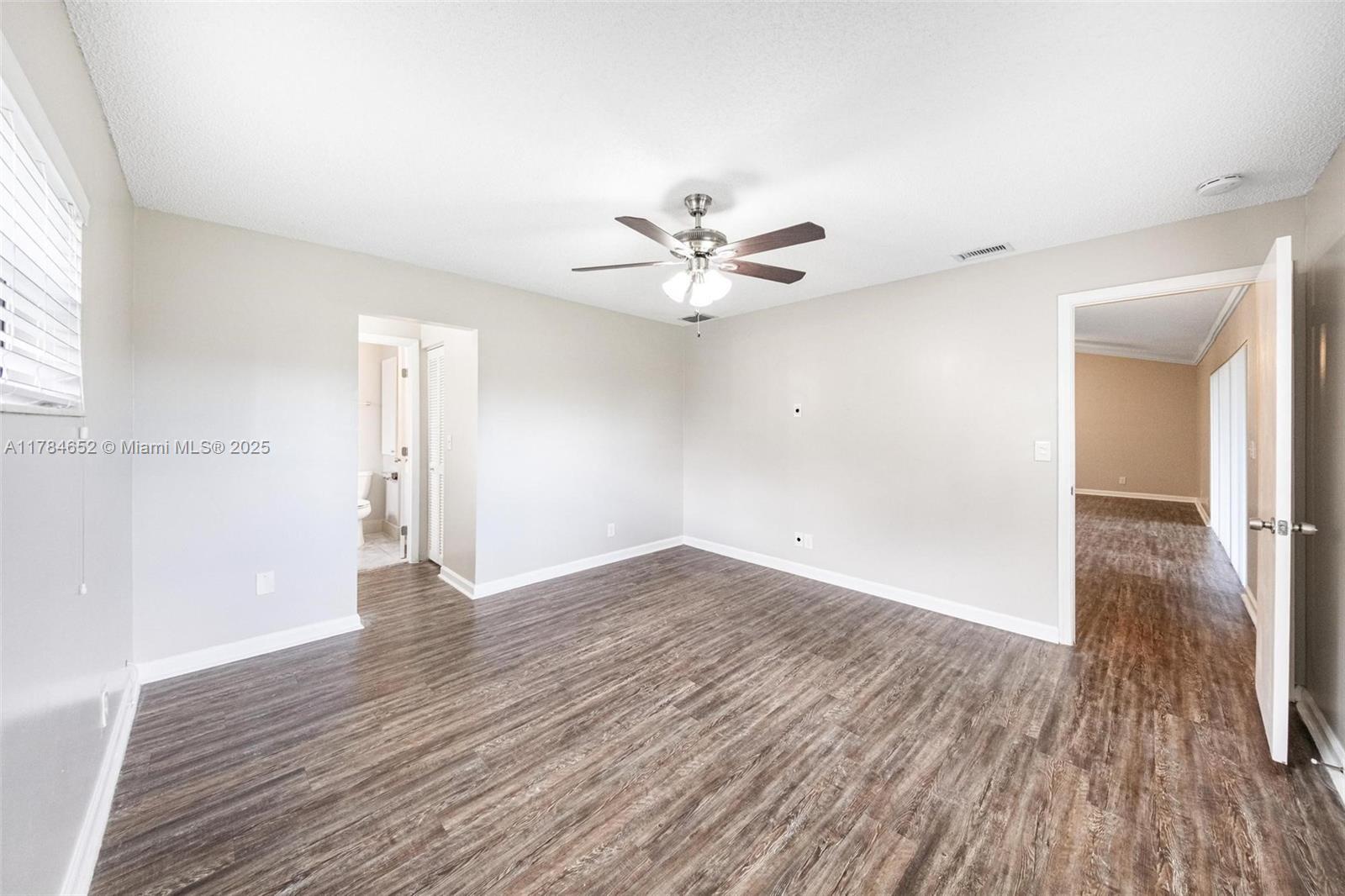 19476 Carolina Circle Boca Raton, FL 33434 - Photo 23 of 52 an empty room with wooden floor and a ceiling fan