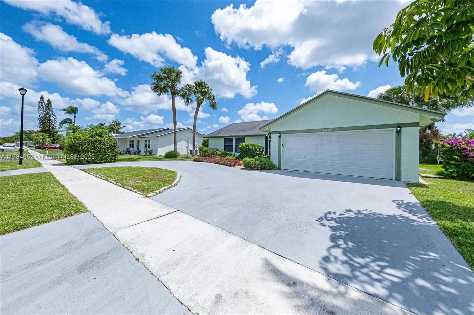 19476 Carolina Circle Boca Raton, FL 33434 - Photo 5 of 52 a front view of a house with garden