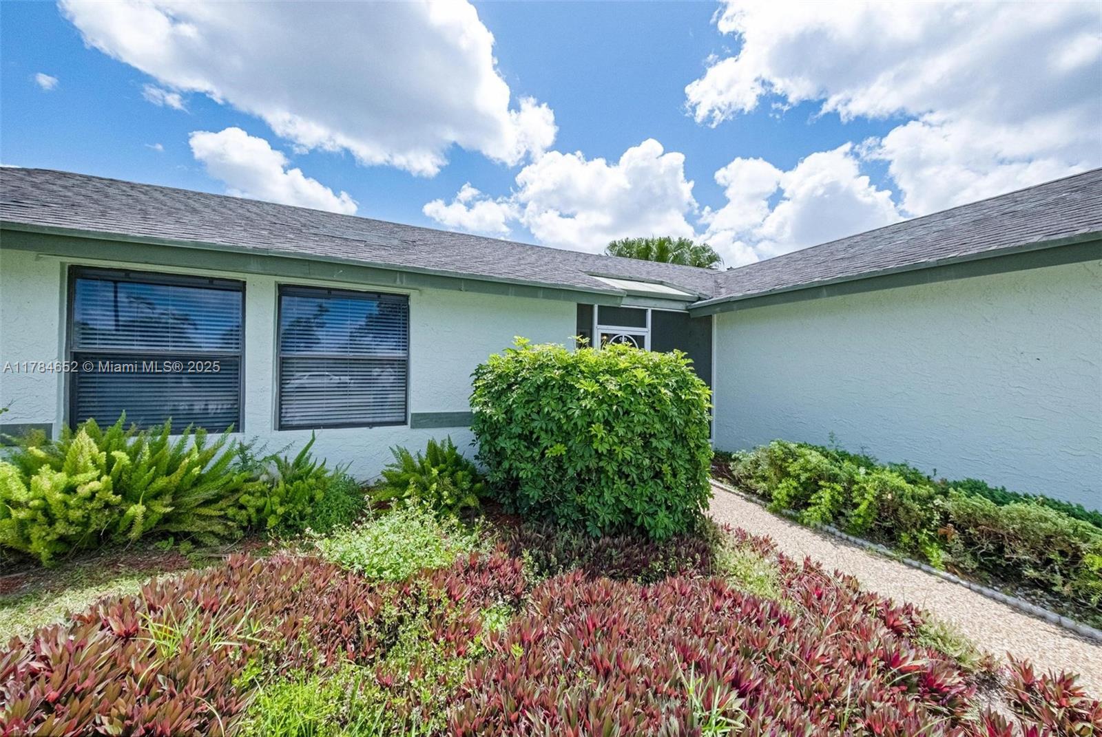 19476 Carolina Circle Boca Raton, FL 33434 - Photo 8 of 52 a front view of a house with garden