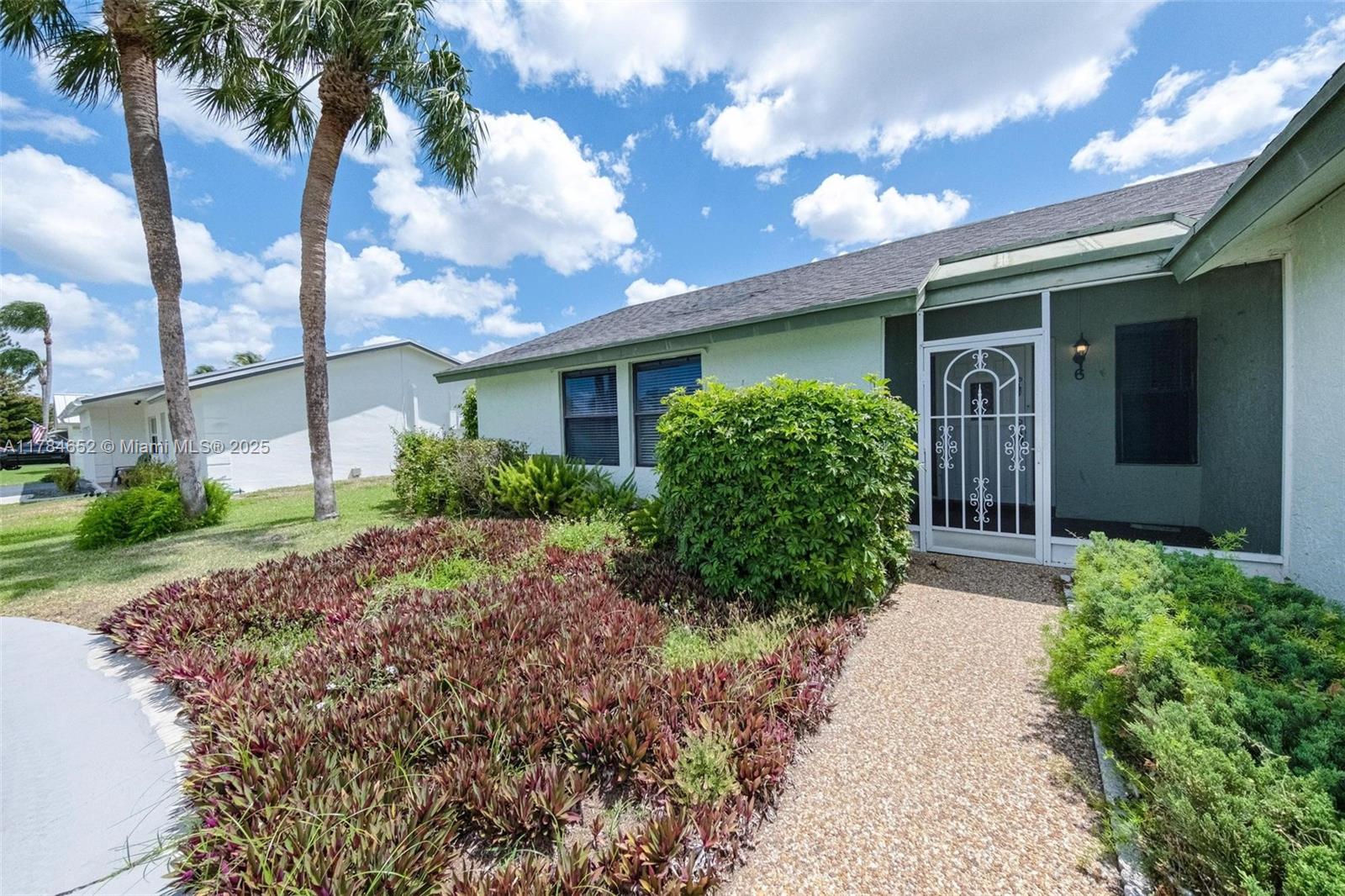 19476 Carolina Circle Boca Raton, FL 33434 - Photo 10 of 52 a front view of a house with garden