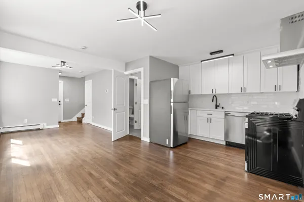 a kitchen with stainless steel appliances a refrigerator and a stove top oven