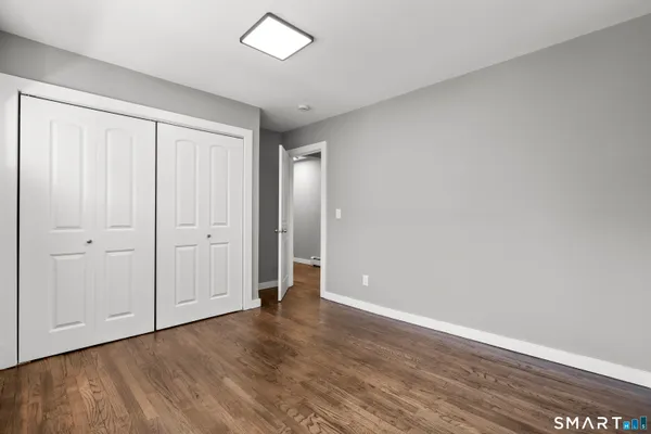 a view of an empty room and wooden floor