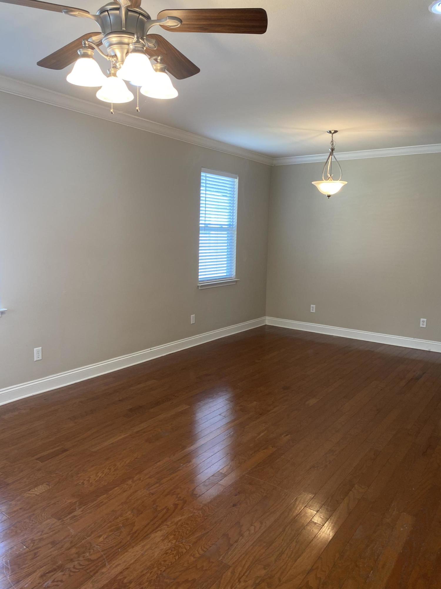 239 County Line Road Niceville, FL 32578 - Photo 7 of 36 a view of a room with wooden floor and a ceiling fan