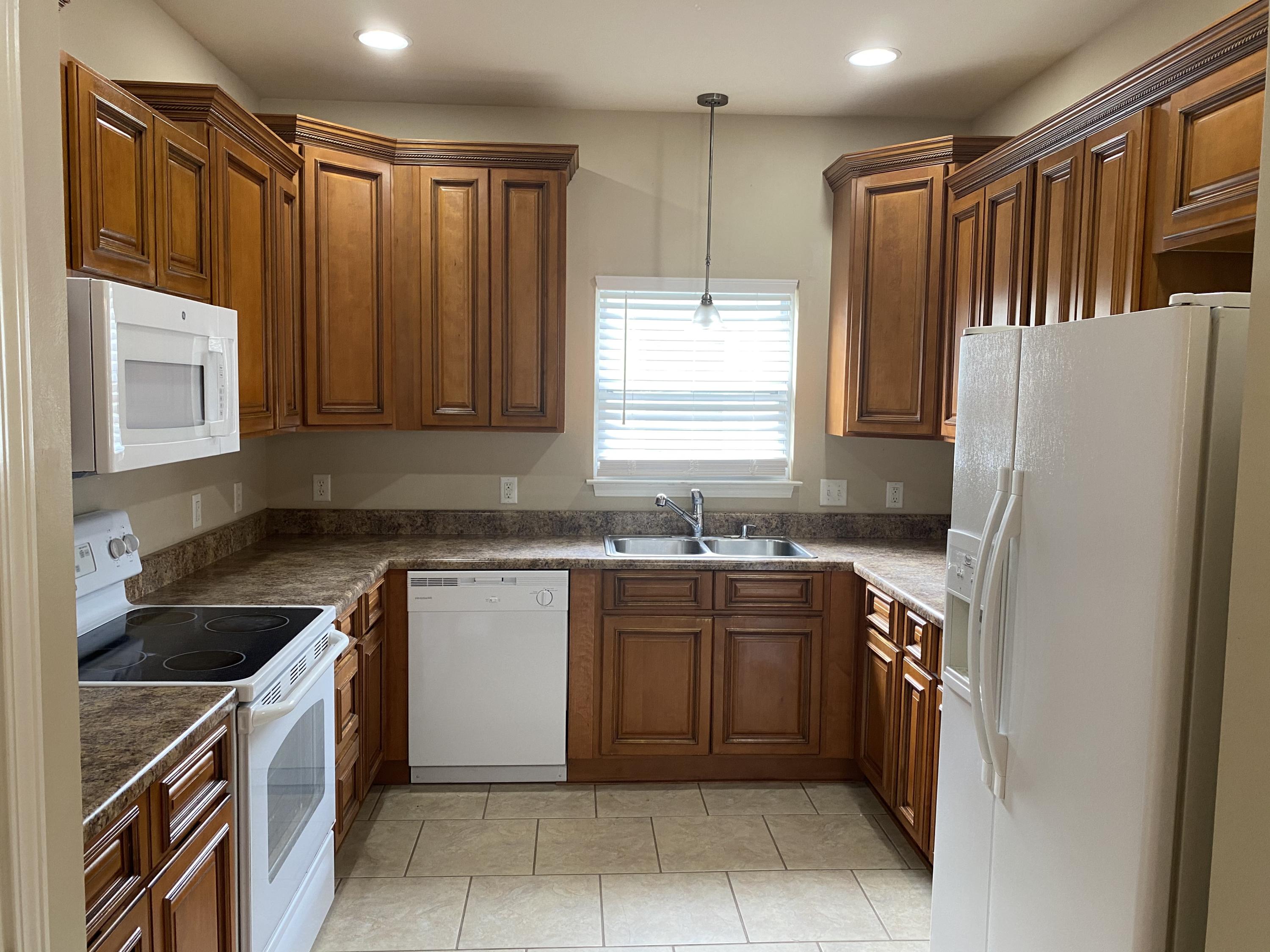 239 County Line Road Niceville, FL 32578 - Photo 9 of 36 a kitchen with a refrigerator and a sink