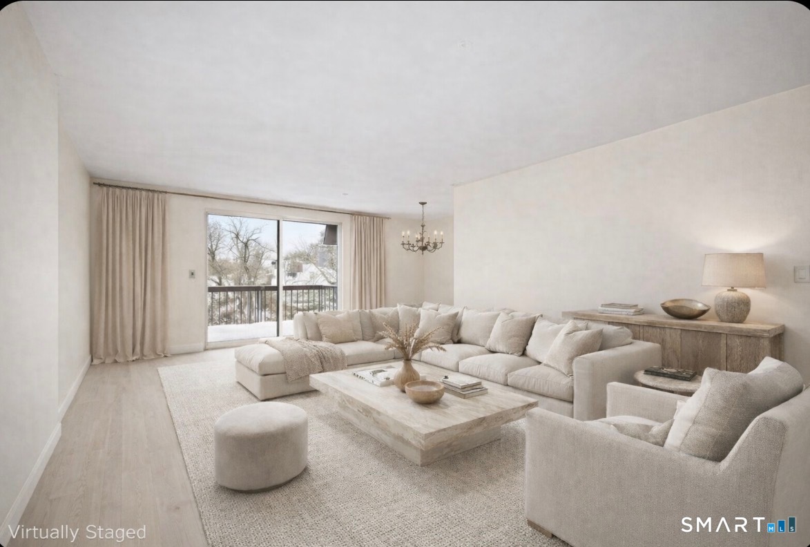 85 Riverside Avenue, Unit F7 Stamford, CT 06905 - Photo 2 of 24 a living room with furniture and a large window