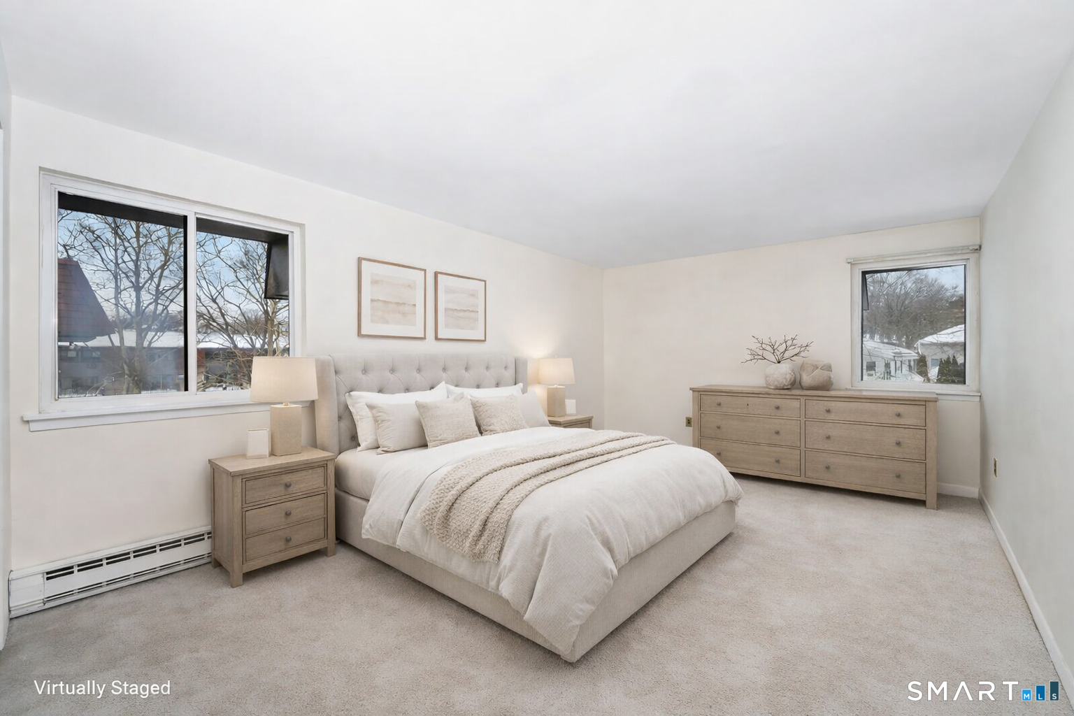 85 Riverside Avenue, Unit F7 Stamford, CT 06905 - Photo 6 of 24 a bedroom with a bed a table and windows