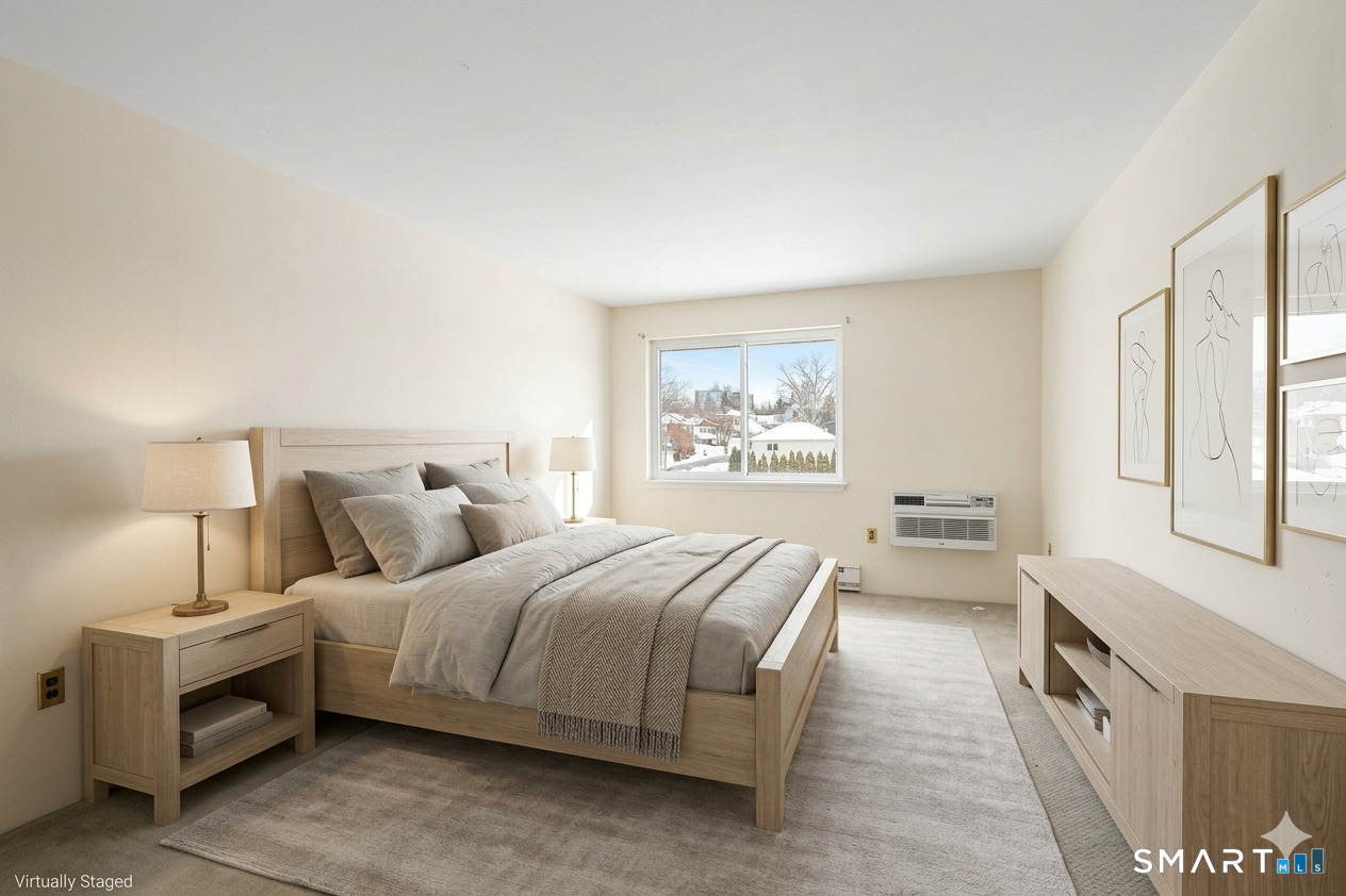 85 Riverside Avenue, Unit F7 Stamford, CT 06905 - Photo 9 of 24 a bedroom with a bed and a large window