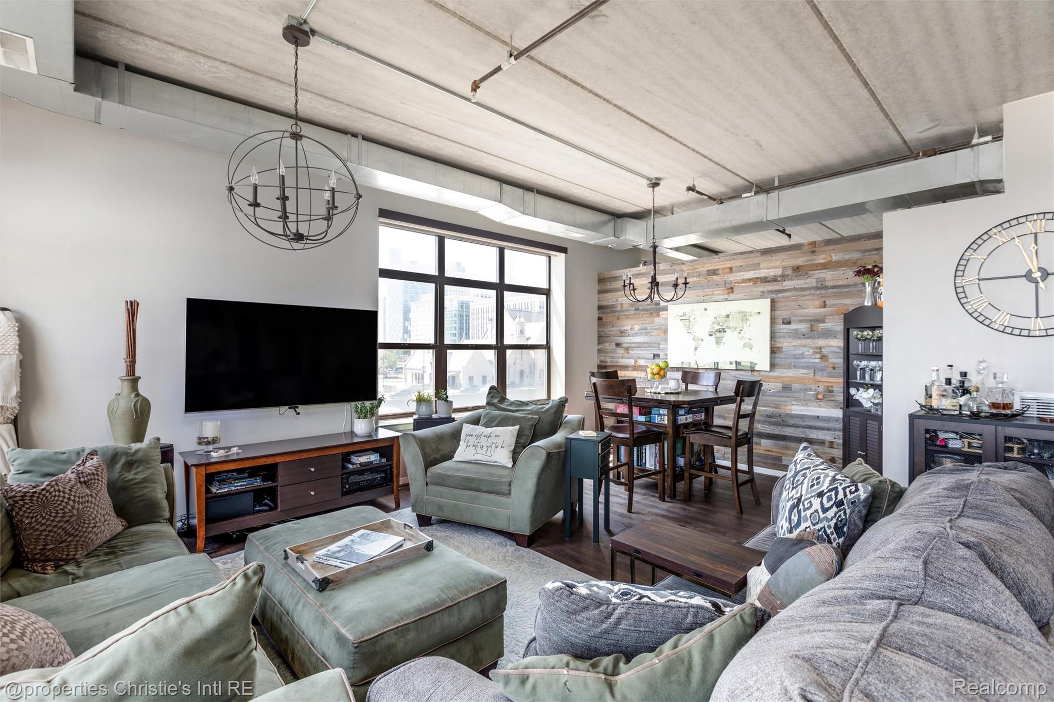 66 Winder Street, Unit 332 Detroit, MI 48201 - Photo 6 of 30 Living area with hanging lights, wooden walls, and wood finished floors