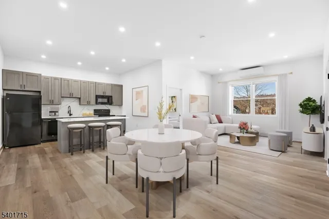 a large kitchen with kitchen island a white cabinets and stainless steel appliances