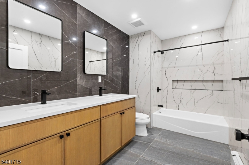 556 Main Street, Unit 2 Orange, NJ 07050 - Photo 8 of 9 a bathroom with a tub sink and mirror