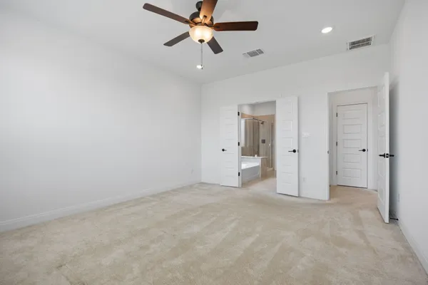 an empty room with fan and a ceiling fan