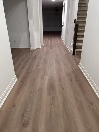 a view of a hallway with wooden floor