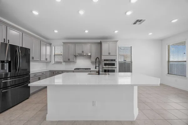 a large kitchen with stainless steel appliances