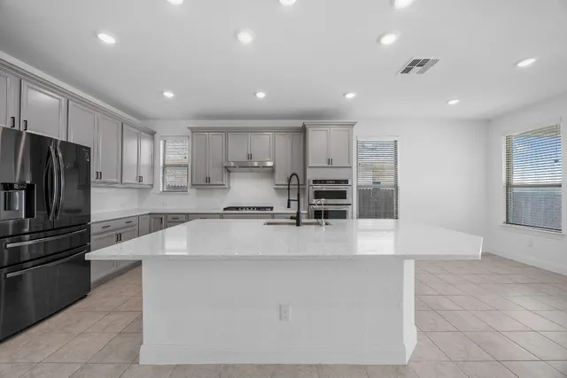 a large kitchen with stainless steel appliances
