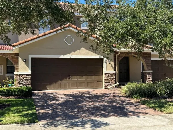 a front view of a house with a yard and garage