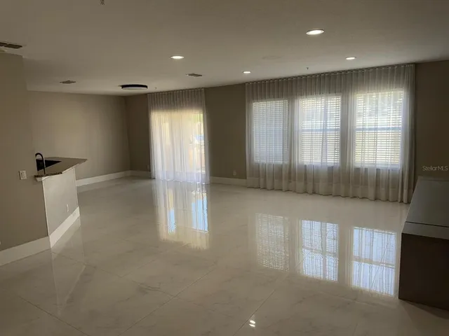 a large kitchen with stainless steel appliances a refrigerator and a sink