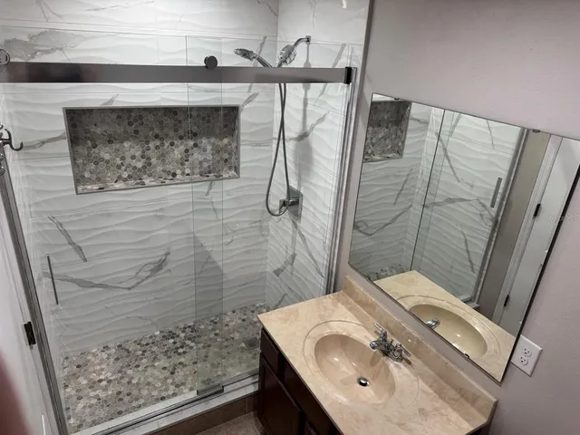 a bathroom with a sink toilet and shower