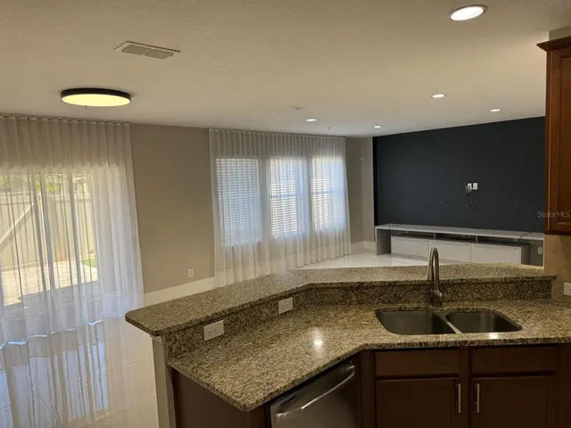 a bathroom with a granite countertop sink a shower and a mirror