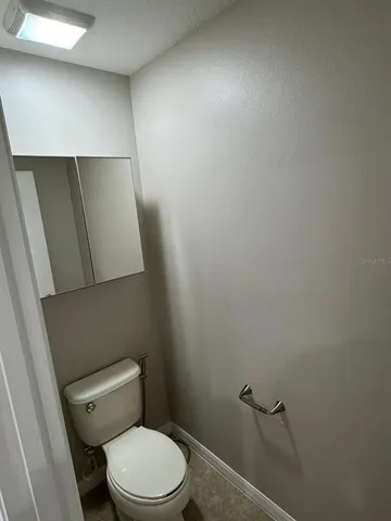 a front view of house and outdoor space with swimming pool and trees