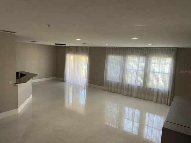 a view of a kitchen with a refrigerator and a sink